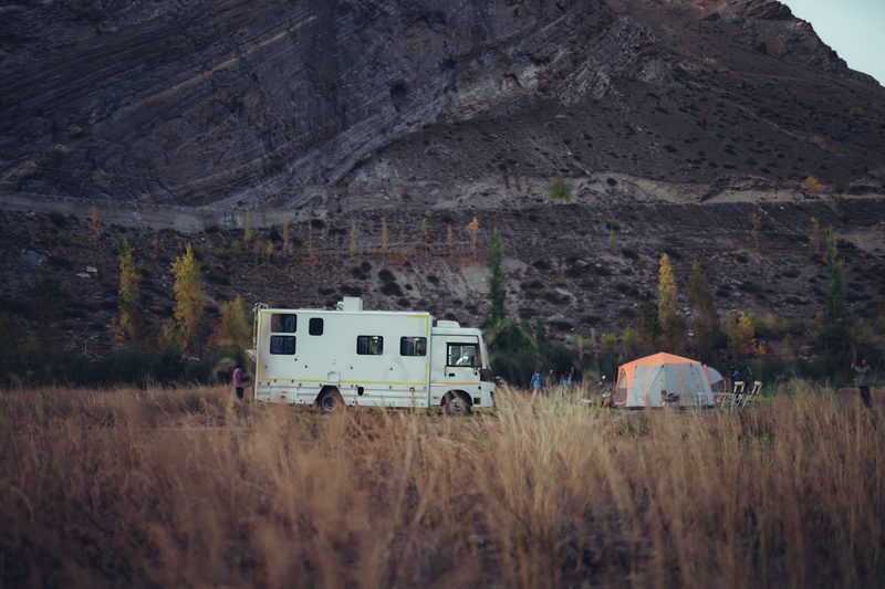 The Explorer caravan camped with an awning in green hill country