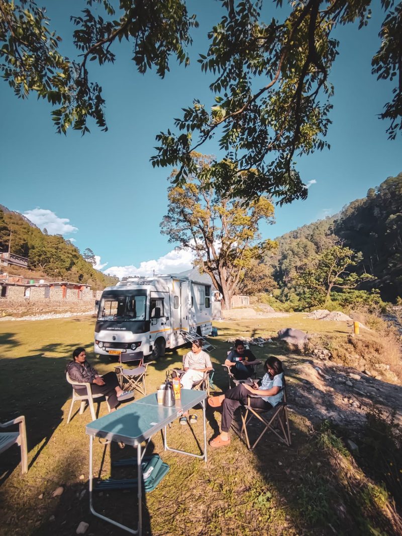 A family relaxing at their campsite beside The Explorer