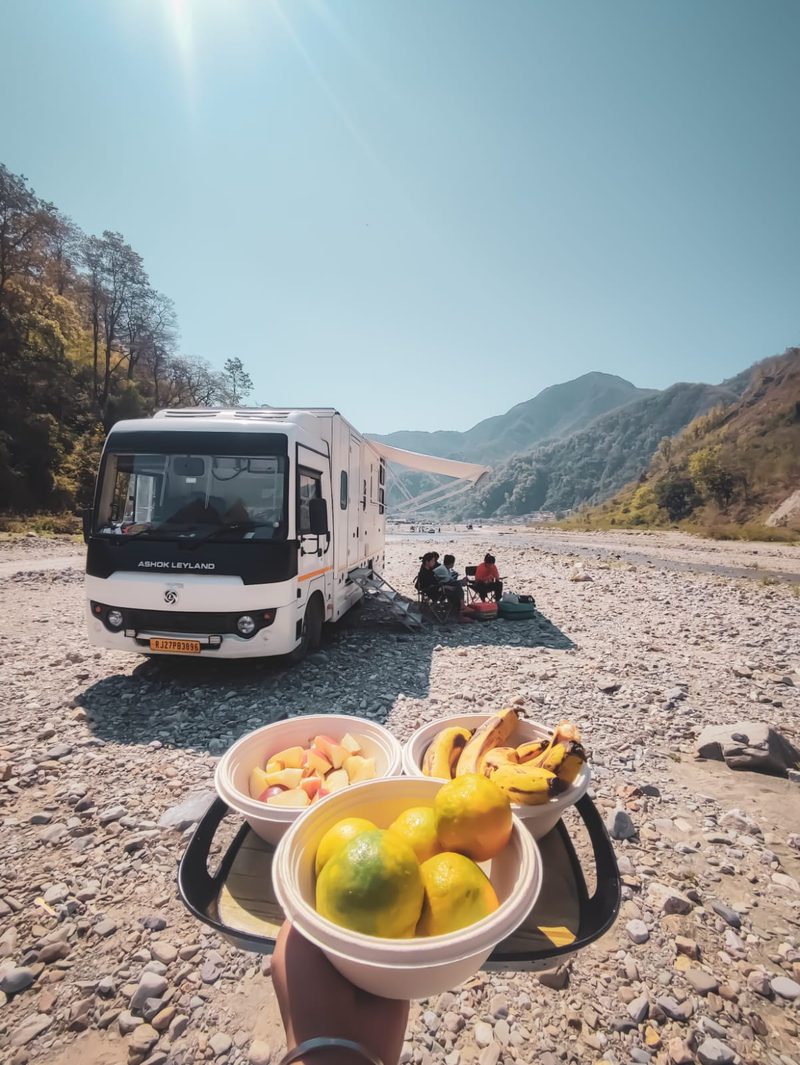 Family relaxing beside the caravan on a Ganges riverside campsite